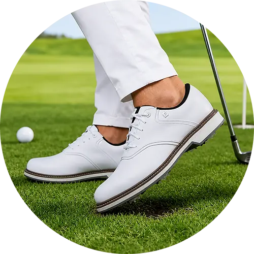 Pair of men’s golf shoes on green grass