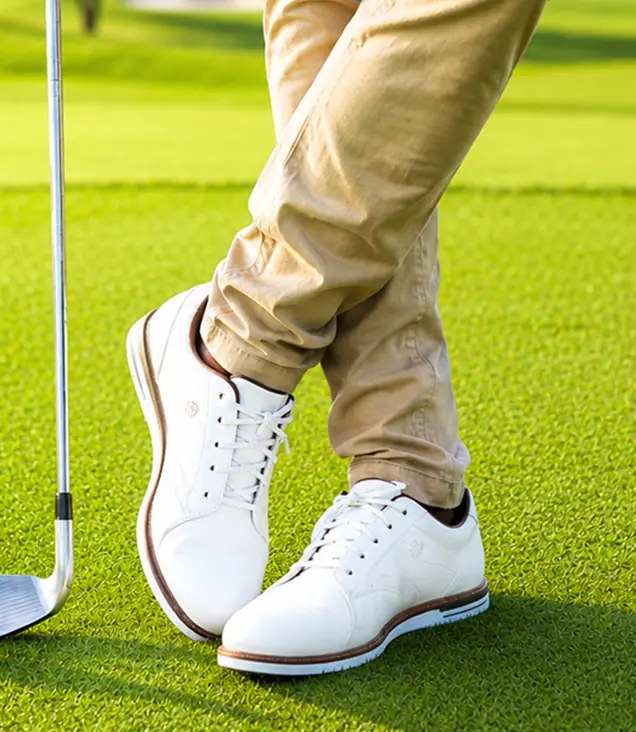 Men's and women's golf shoes on the golf course